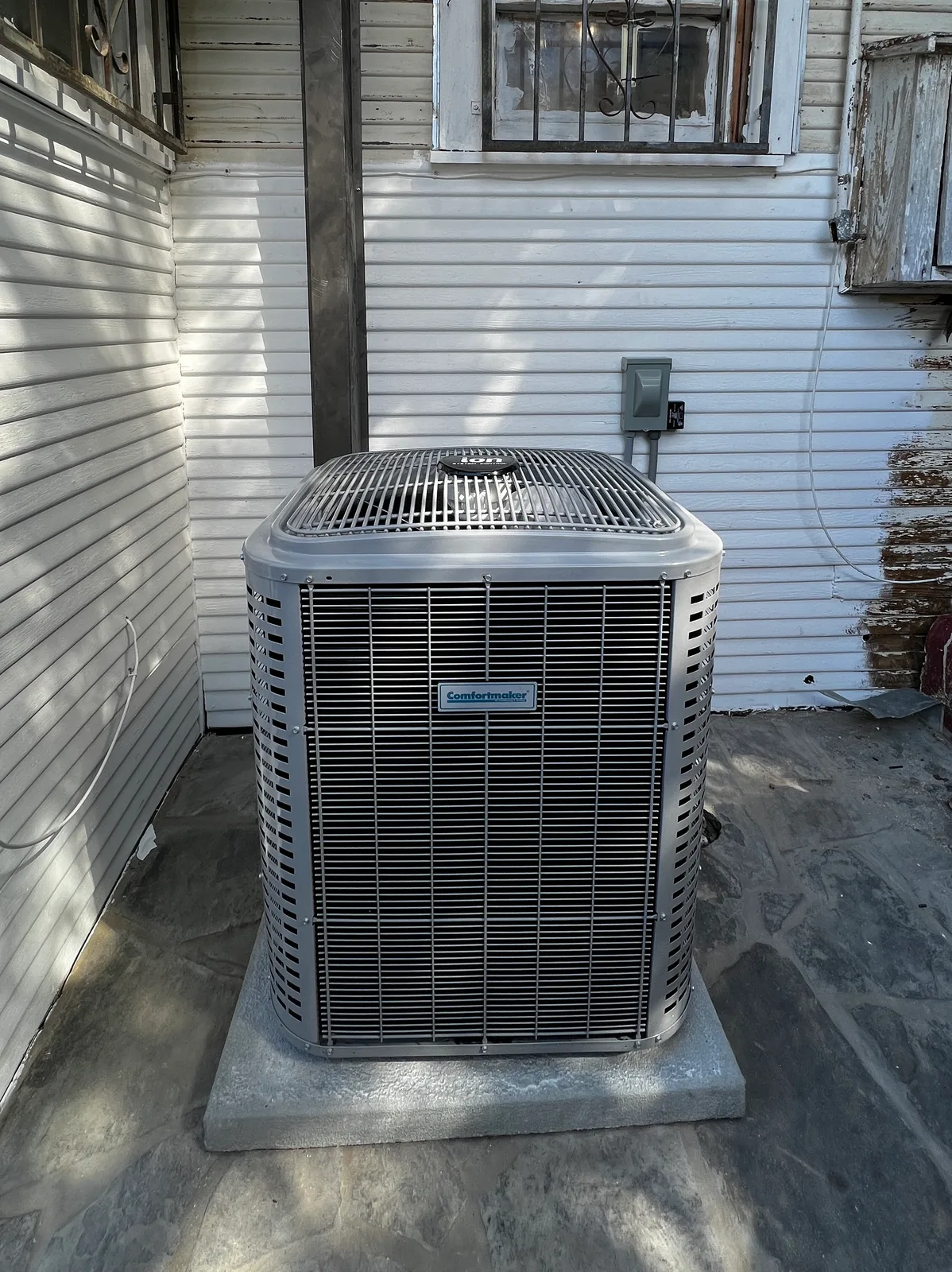 A newly installed outdoor AC condenser beside a Texas home.