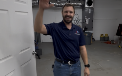 A certified Moorhead Service Company technician installing a whole-home dehumidifier unit.